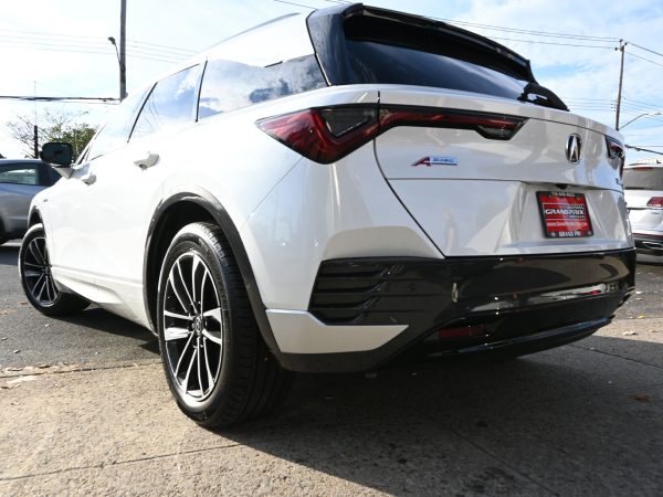 Dynamic driving shot of the 2024 Acura ZDX in motion.