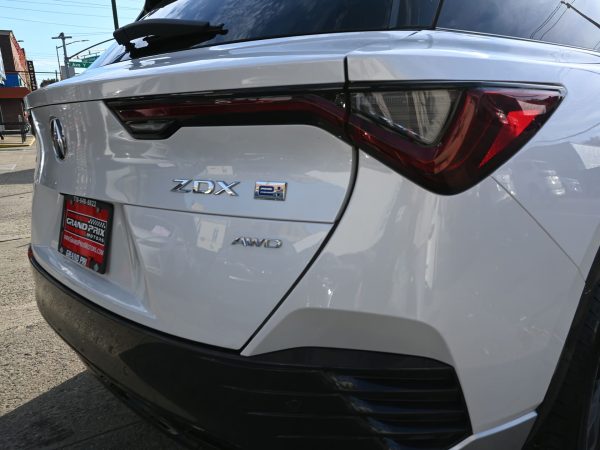 - Side profile of the ZDX with 22-inch wheels and sculpted EV silhouette - Rear view of the ZDX highlighting Chicane™ LED taillights and aerodynamic design