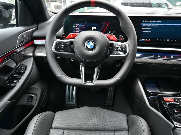 nterior shot of the BMW M5 Hybrid, featuring M Carbon bucket seats and illuminated M badging.