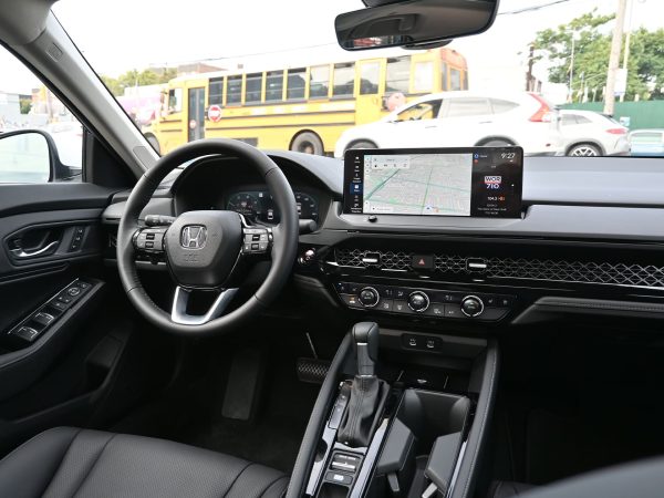 Driver using voice control on the Accord’s infotainment system with Google Assistant.
