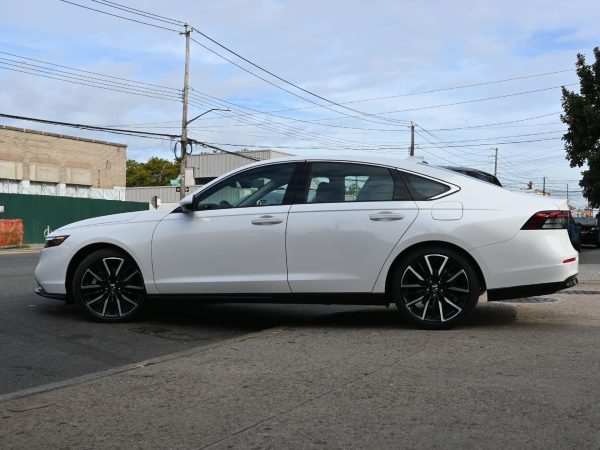 2025 Honda Accord driving on a scenic highway, emphasizing fuel efficiency.