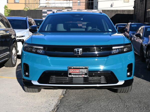 Honda Prologue plugged into a DC fast charger at a public EV station.