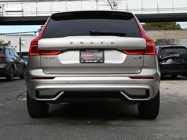 XC60 charging at a public EV station, highlighting its plug-in hybrid capability.