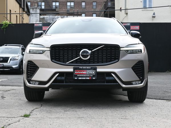 XC60 charging at a public EV station, highlighting its plug-in hybrid capability.
