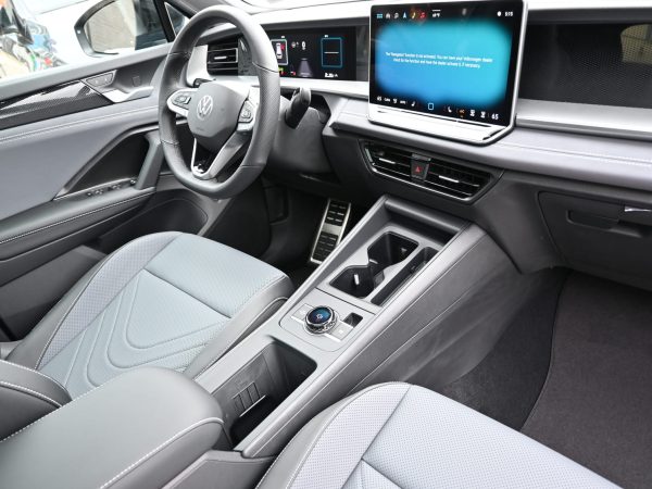 river’s perspective inside the 2025 Tiguan, showing IQ.DRIVE safety interface and wireless Apple CarPlay display