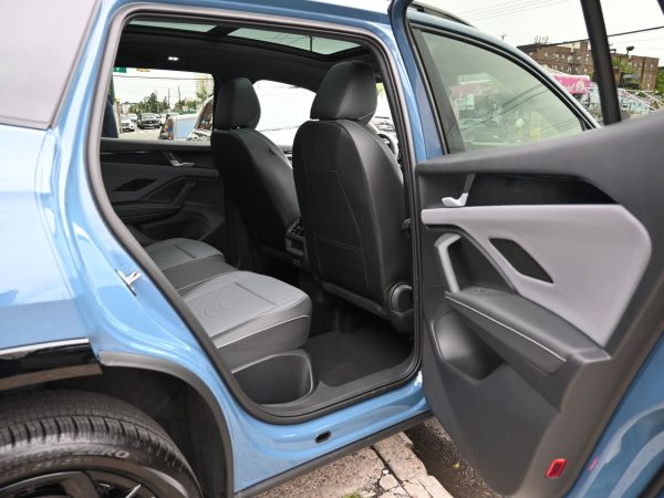 ear view of the 2025 Tiguan in motion, demonstrating LED taillights and sculpted rear spoiler