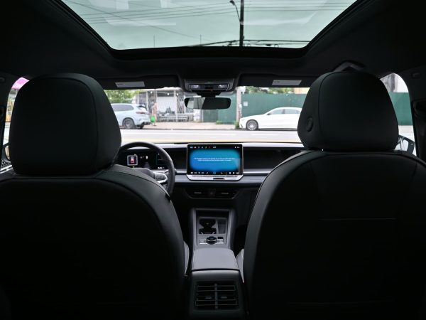 Interior view of the 2025 Tiguan featuring walnut trim, quilted leather seats, and 15-inch touchscreen with MIB4 infotainment and a panoramic view
